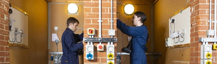 Two students working in electrical workshop