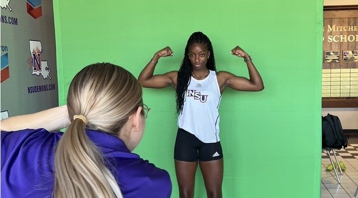 Sileena Farrell, NKC student flexing her muscles whilst being photgraphed