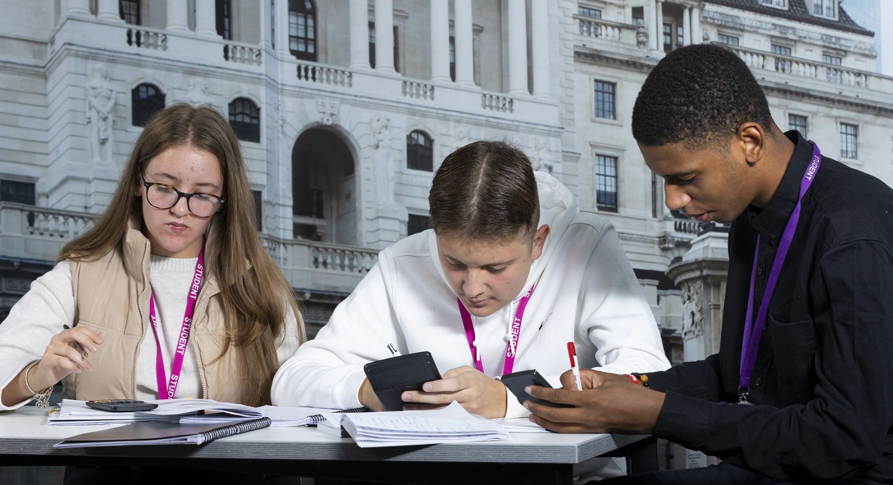 Students looking at calculator and paper