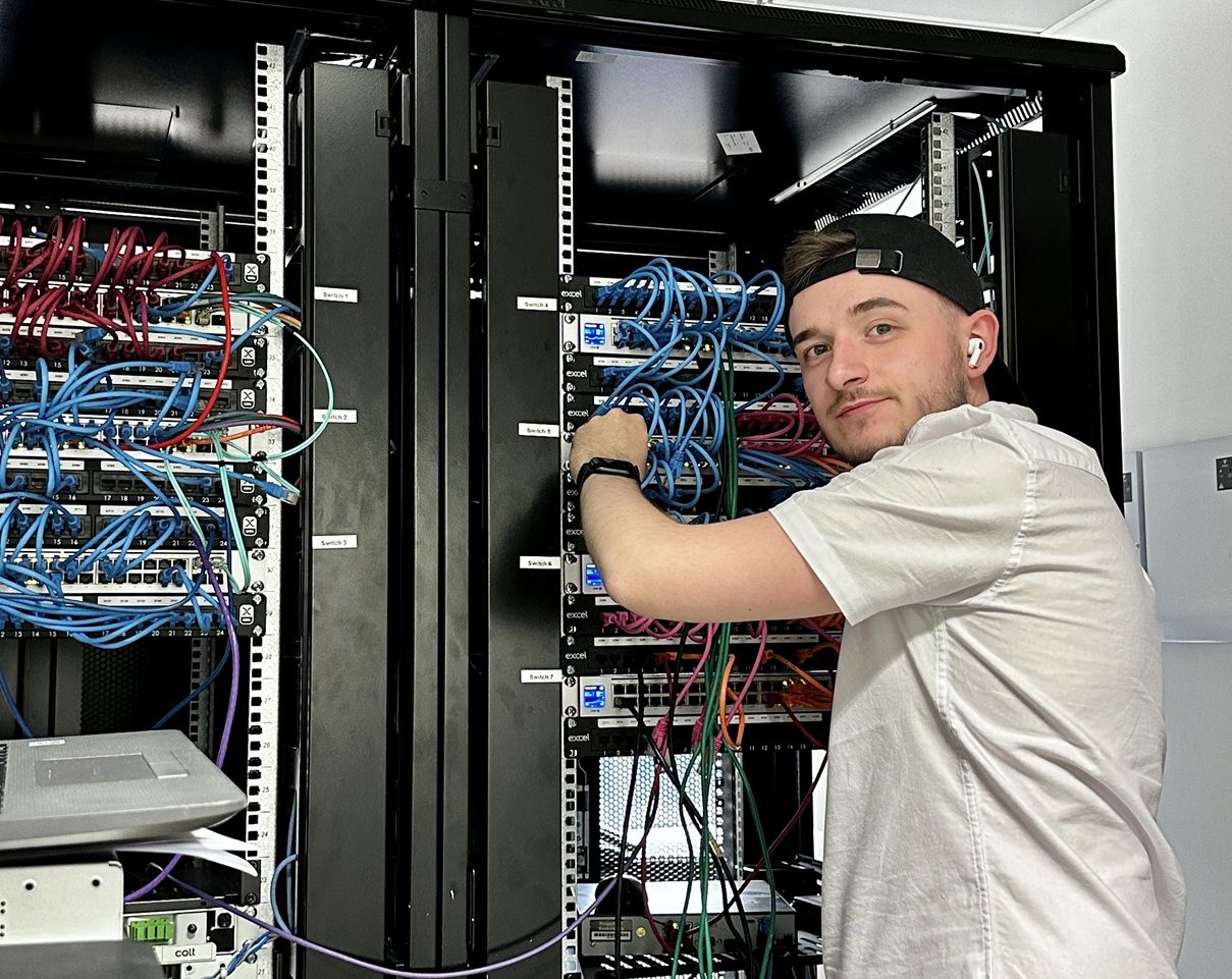 Man working on computer networking box