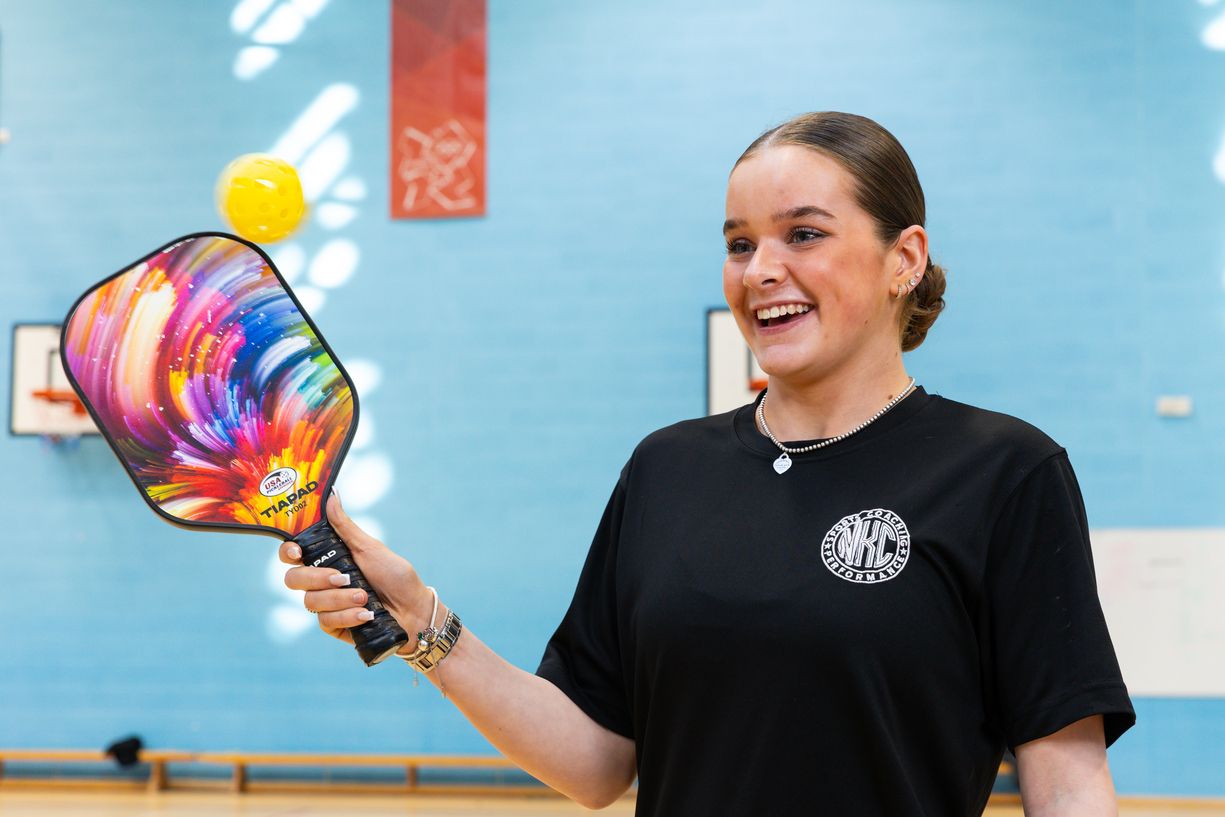 female_sports_student_with_bat_and_ball