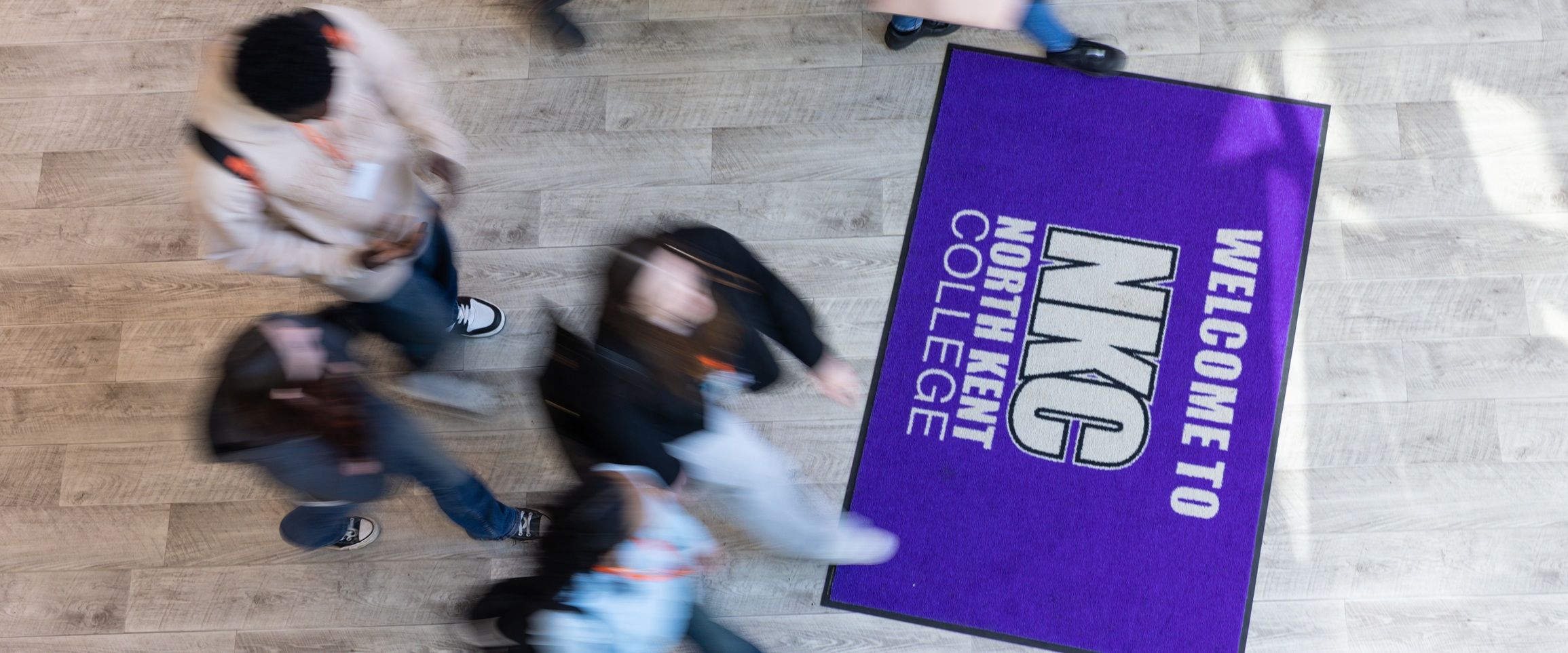 Student walking across NKC mat