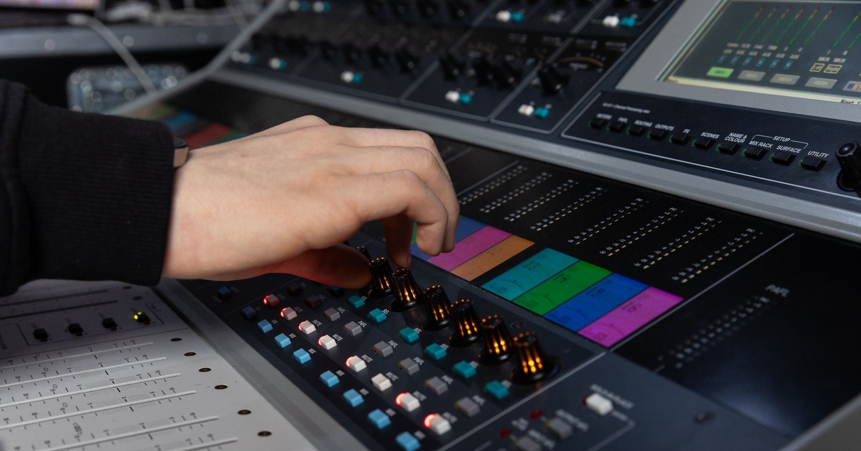 Hand on dashboard controlling theatre lighting etc