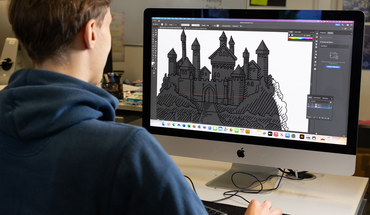 STudent in front of computer screen looking at illustration