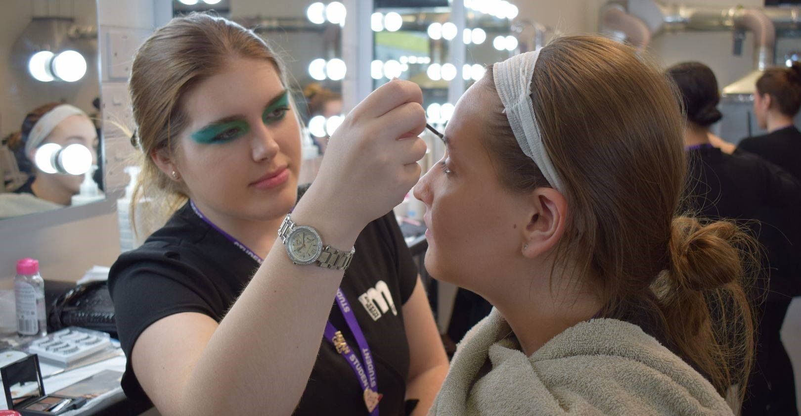 One young female doing another young female's mark up