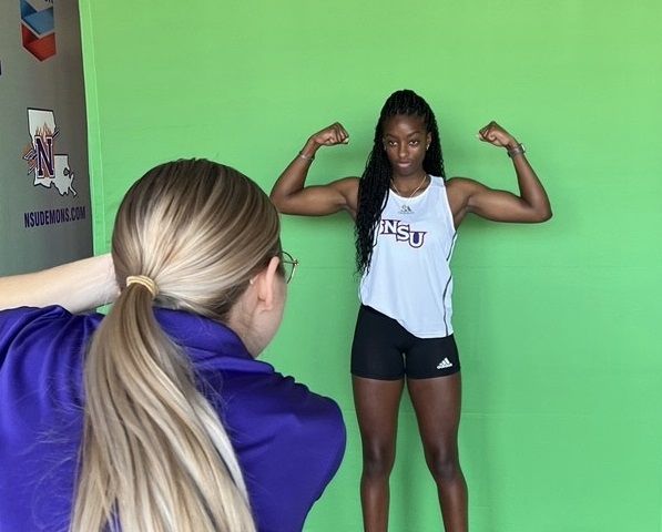 Sileena Farrell, NKC student flexing her muscles whilst being photgraphed