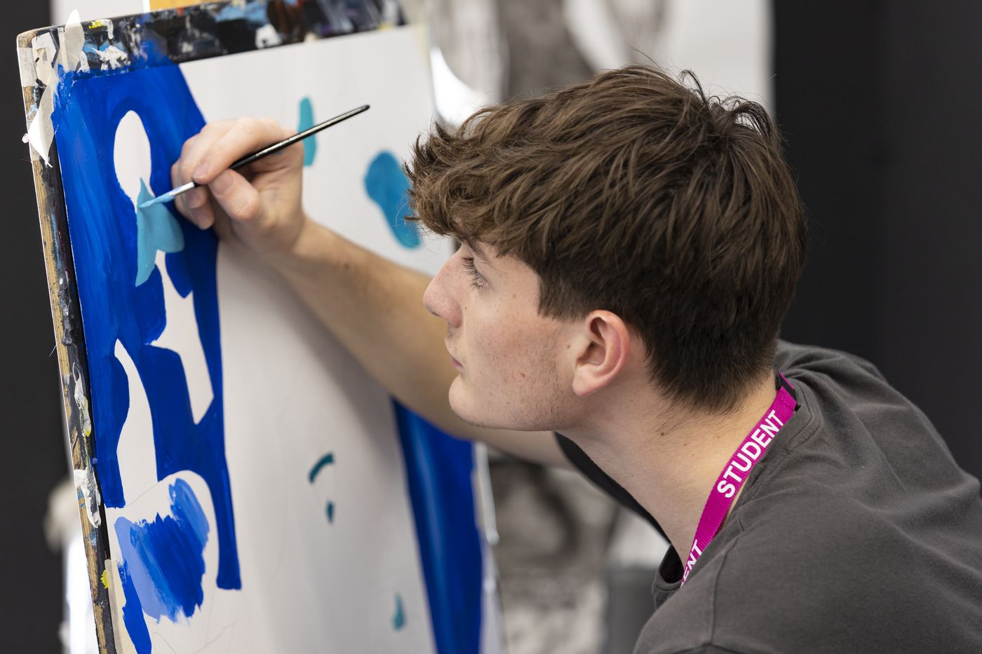 male-art-student-painting-on-canvas