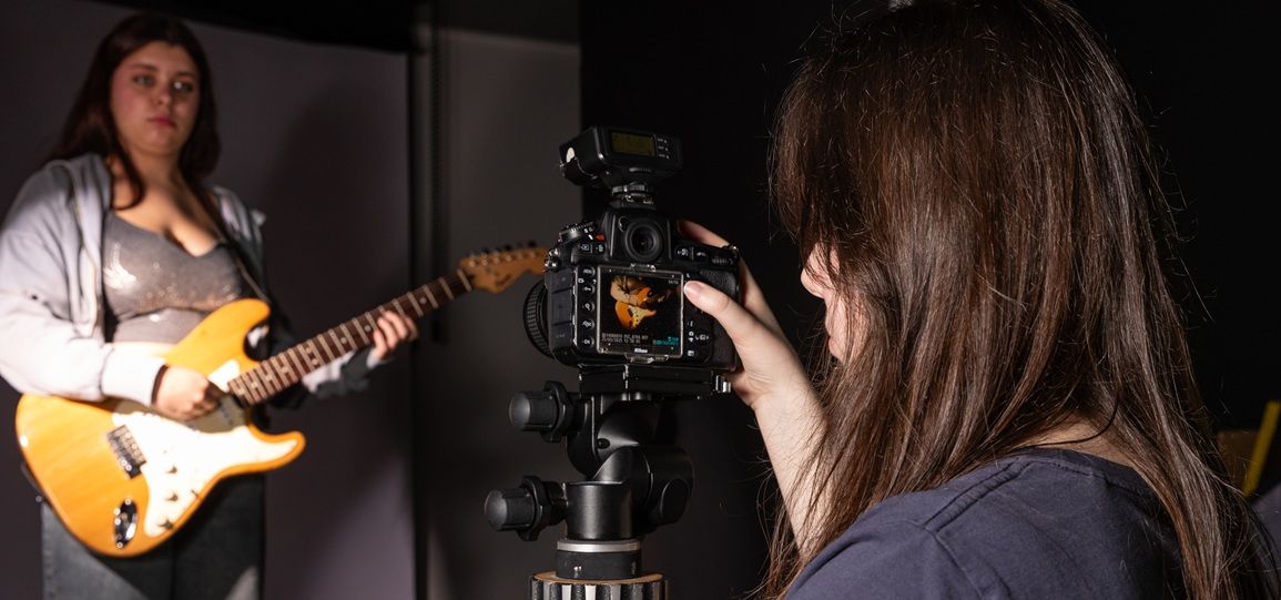 Student with camera taking photo