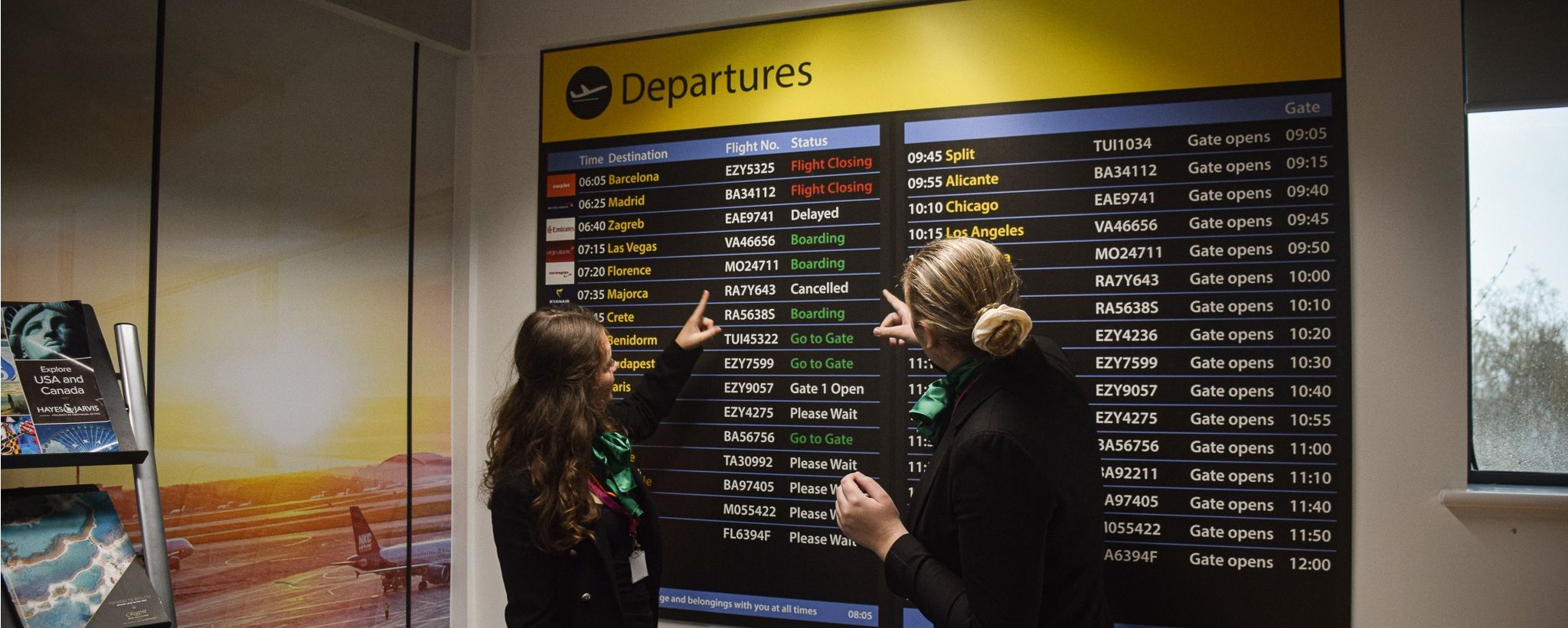 Students looking at mock departure board