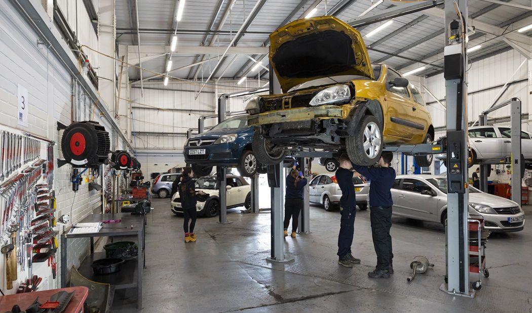 Students working on motor vehicles