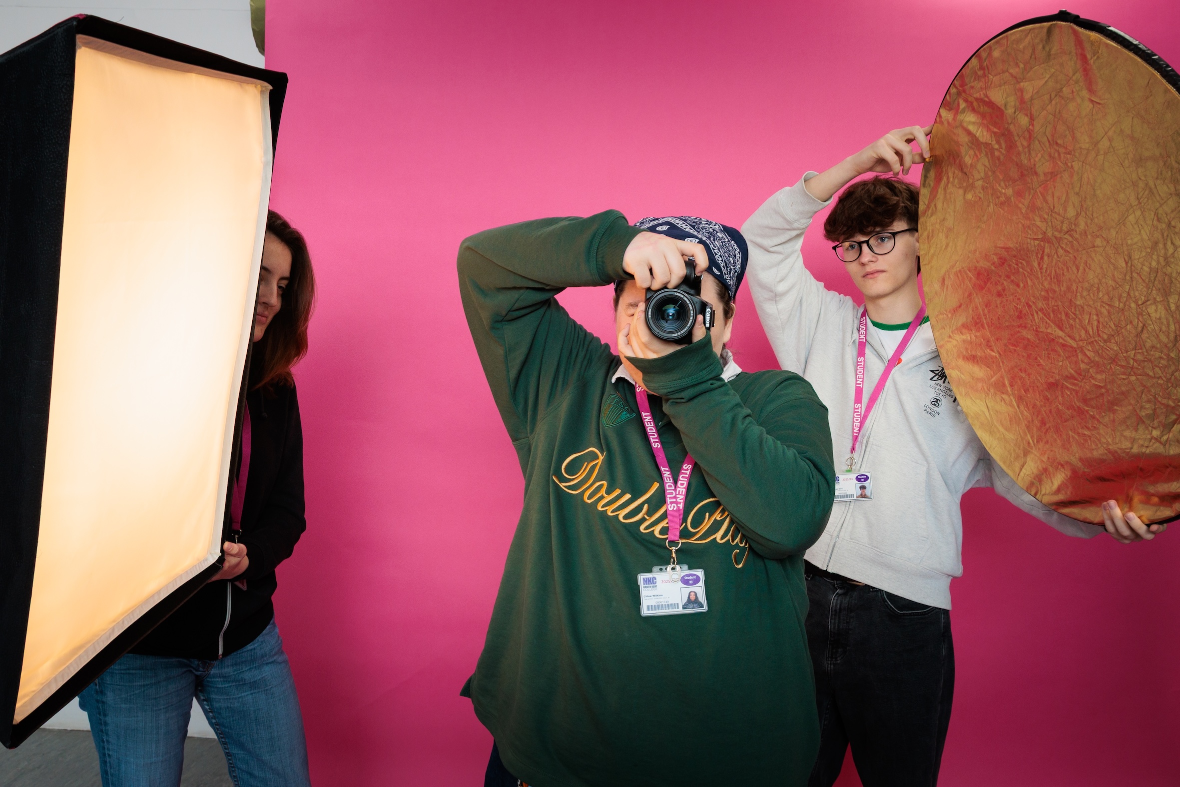 Students looking into camera through photography camera
