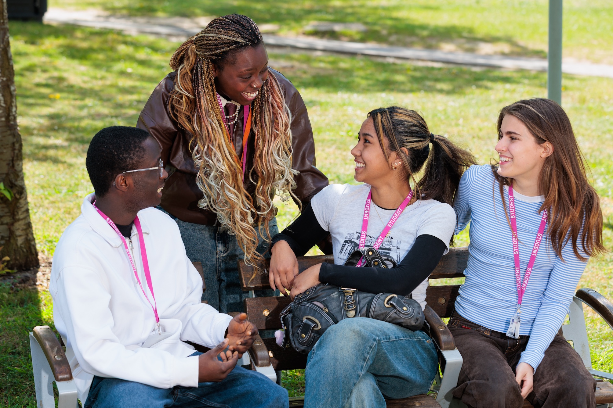 Group of college students sitting on bench