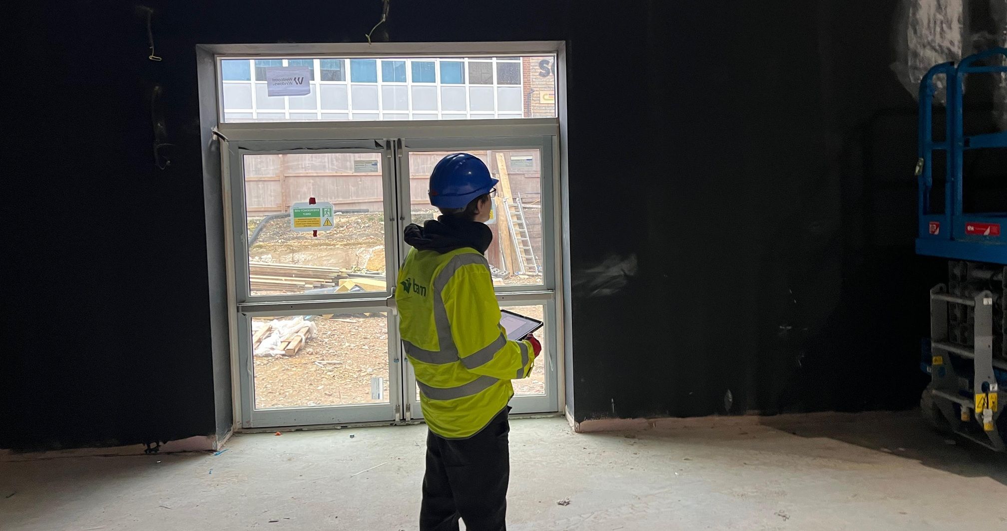 Young man on construction site in hi vis
