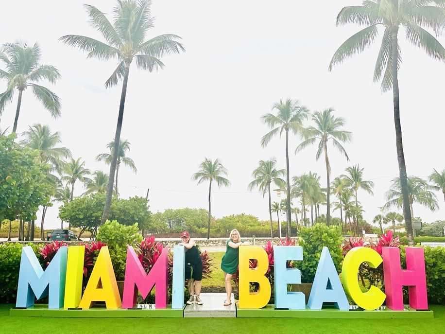 Miami Beach sign with palm trees behind