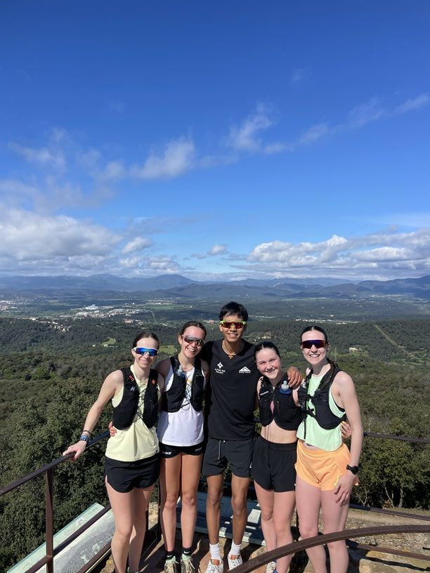 Group of young people on hill with scenic view behind