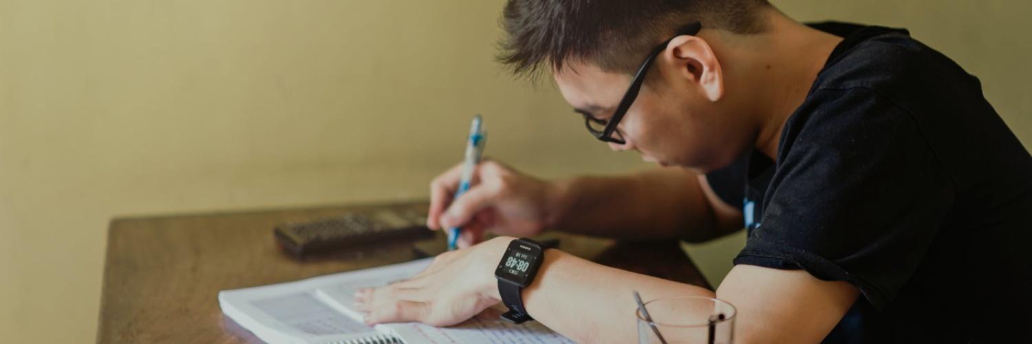 Male student studying with textbook