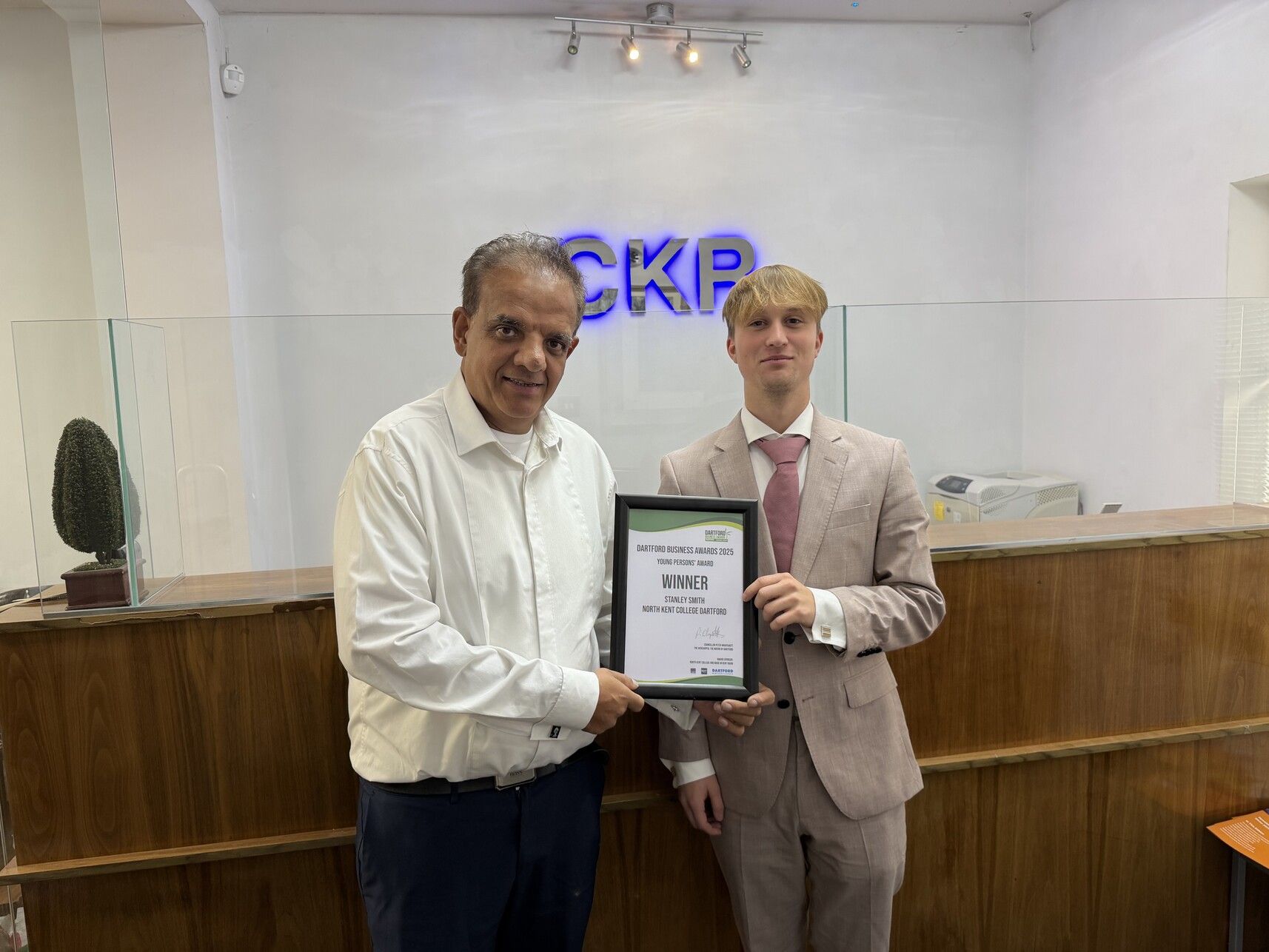 employer handing award to student